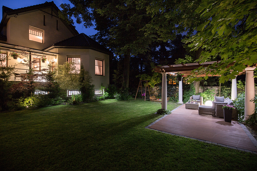 Luxury residence with beauty patio - view at night. Landscape lighting.